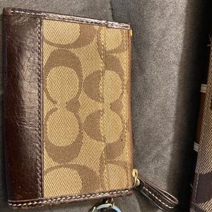 Brown and tan coach purse with feet